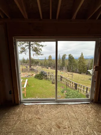 a view of a house with backyard porch and furniture