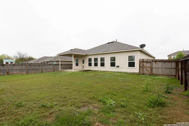 a backyard of a house with lots of green space and lake view