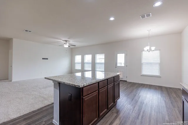 a kitchen with a wooden floor and window