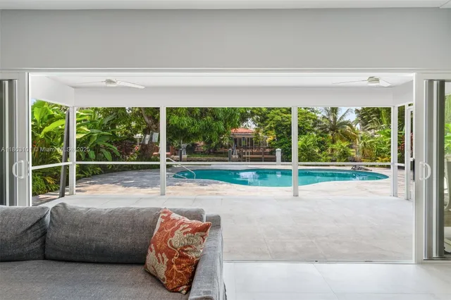 a living room with a large window and outer view
