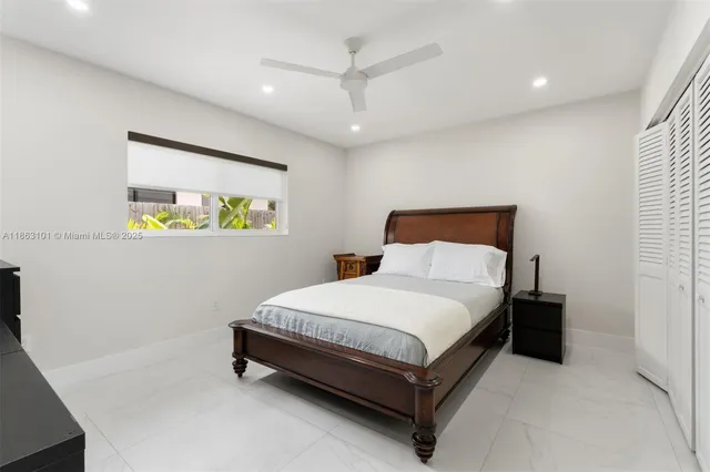 a bed sitting in a bedroom next to a window