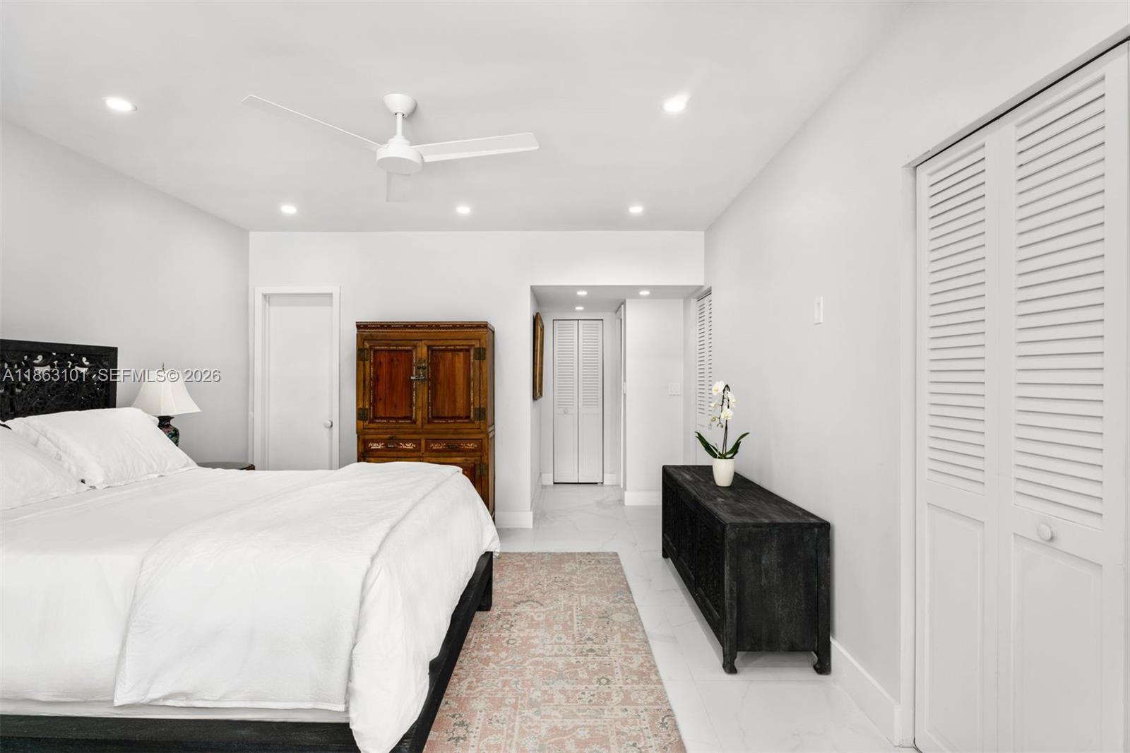 1410 Cleveland Road Miami Beach, FL 33141 - Photo 13 of 17 a bedroom with a bed and a walk in closet
