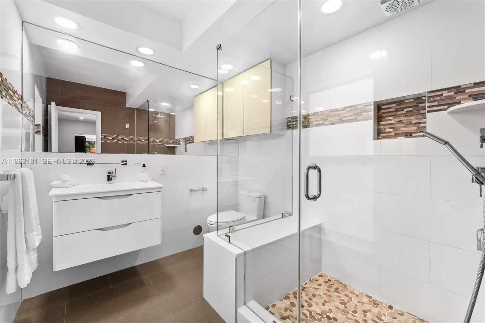 1410 Cleveland Road Miami Beach, FL 33141 - Photo 15 of 17 a bathroom with a sink a toilet and shower