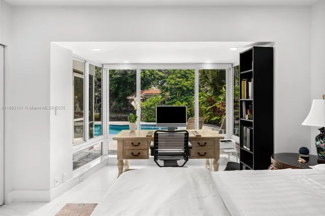 a view of a workspace with furniture and a window
