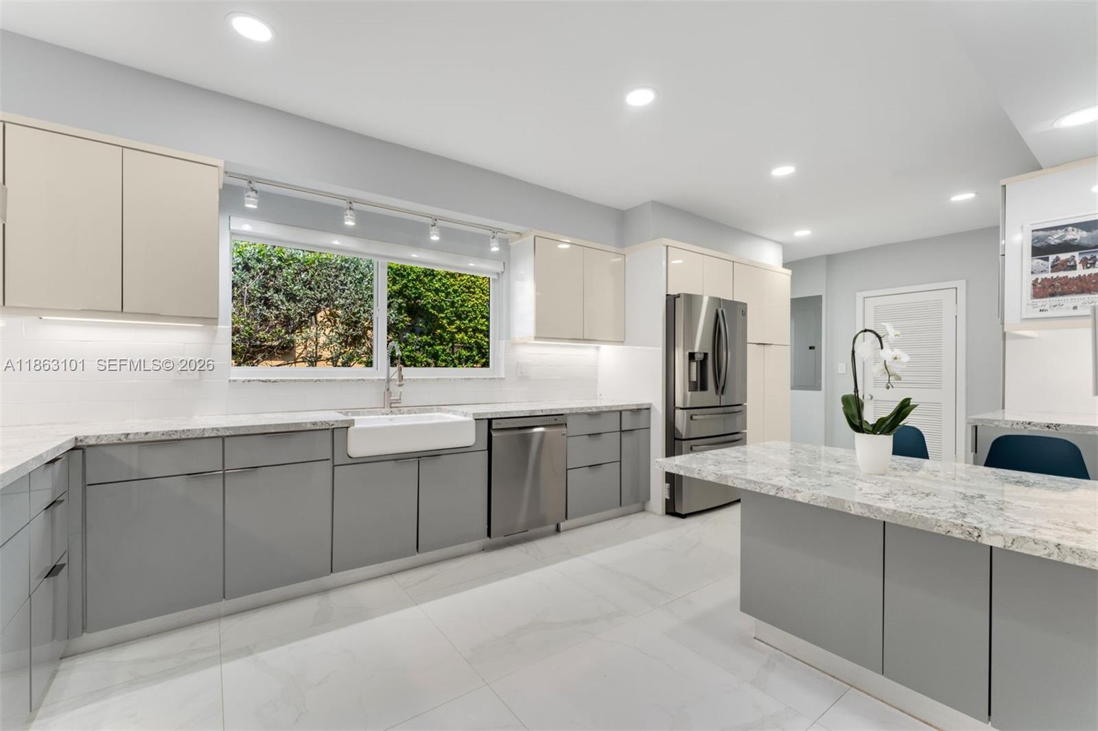 1410 Cleveland Road Miami Beach, FL 33141 - Photo 2 of 17 a kitchen with counter top space sink and stainless steel appliances