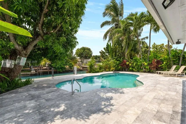 a view of a backyard with swimming pool