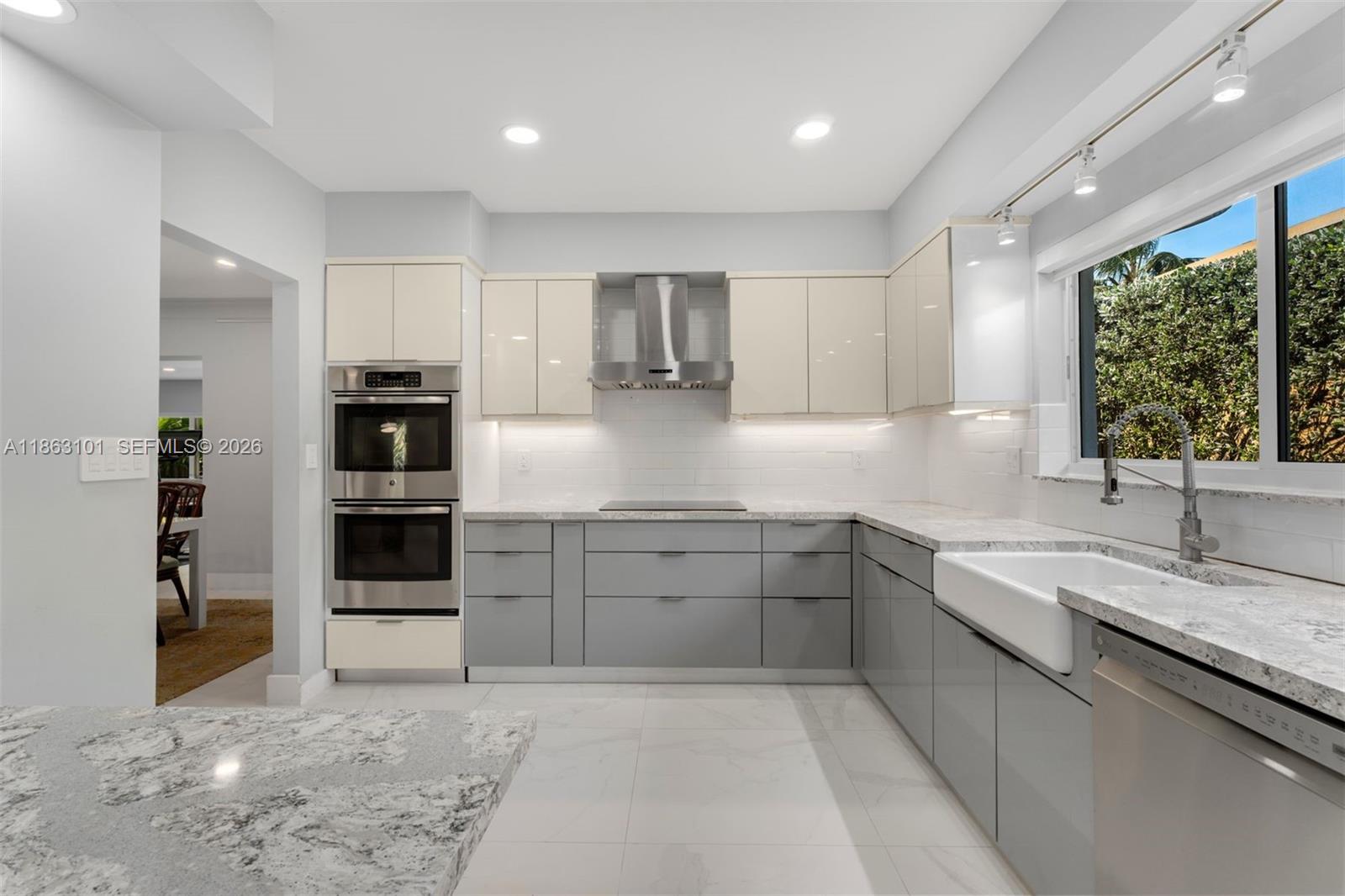 1410 Cleveland Road Miami Beach, FL 33141 - Photo 3 of 17 a kitchen with stainless steel appliances granite countertop a sink stove and cabinets