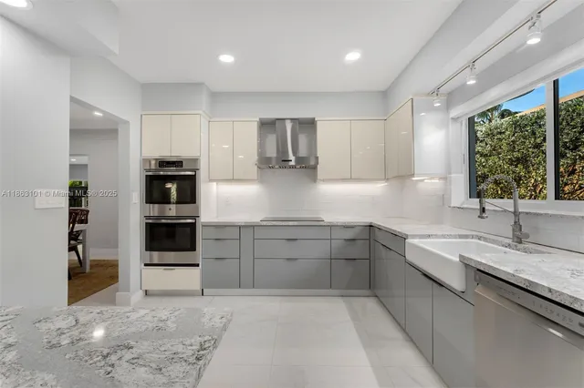 a kitchen with stainless steel appliances granite countertop a sink stove and cabinets
