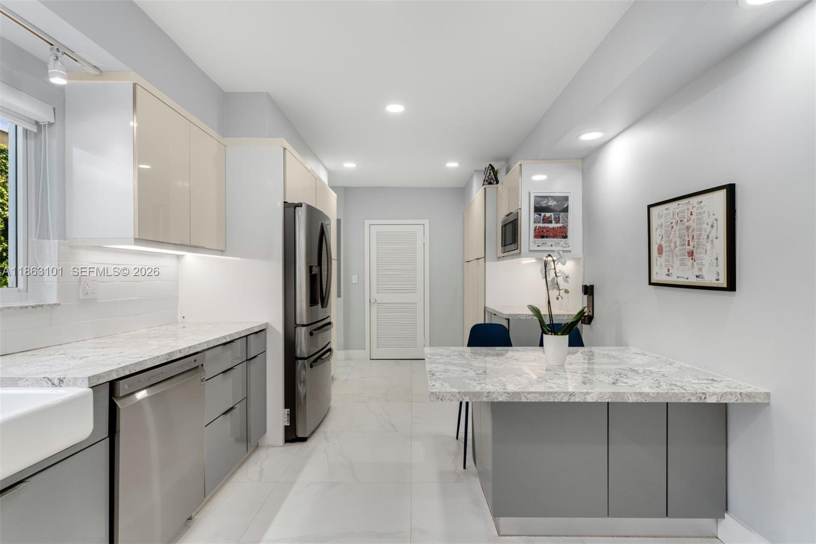 1410 Cleveland Road Miami Beach, FL 33141 - Photo 4 of 17 a kitchen with stainless steel appliances granite countertop a sink and refrigerator