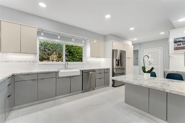 a kitchen with counter top space sink and stainless steel appliances
