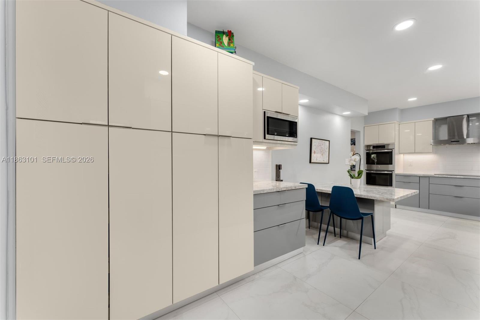 1410 Cleveland Road Miami Beach, FL 33141 - Photo 5 of 17 a kitchen with a refrigerator and a dining table