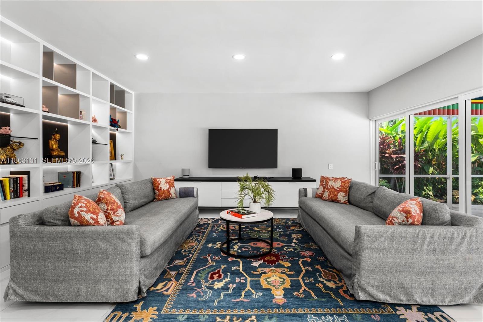 1410 Cleveland Road Miami Beach, FL 33141 - Photo 6 of 17 a living room with furniture and a flat screen tv