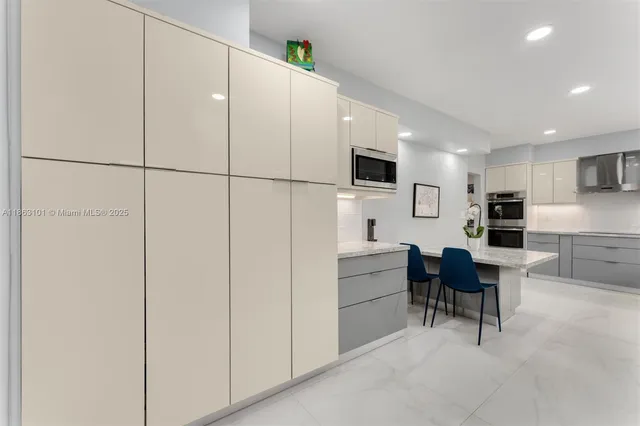 a kitchen with a refrigerator and a dining table