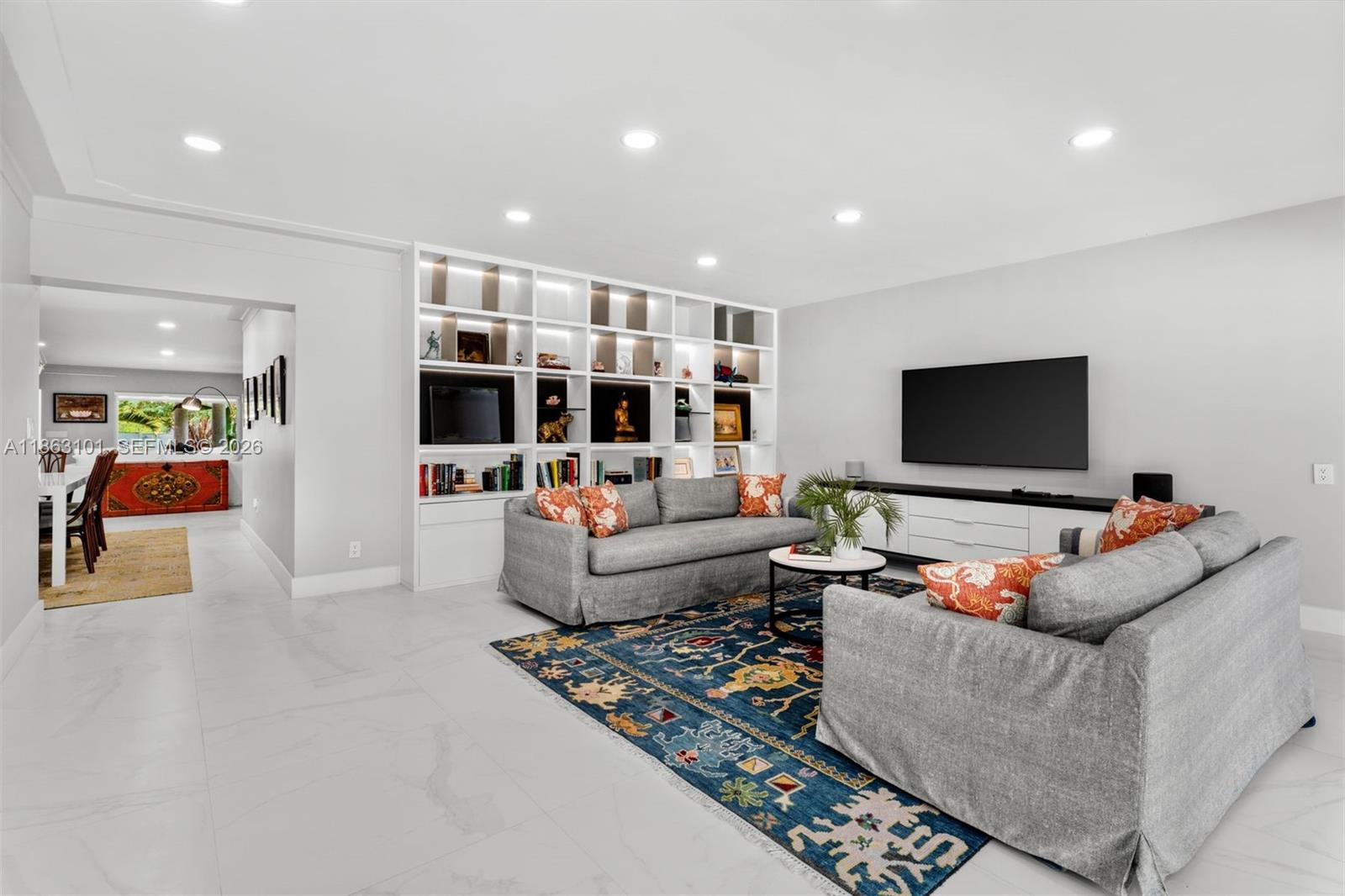 1410 Cleveland Road Miami Beach, FL 33141 - Photo 7 of 17 a living room with furniture and a flat screen tv