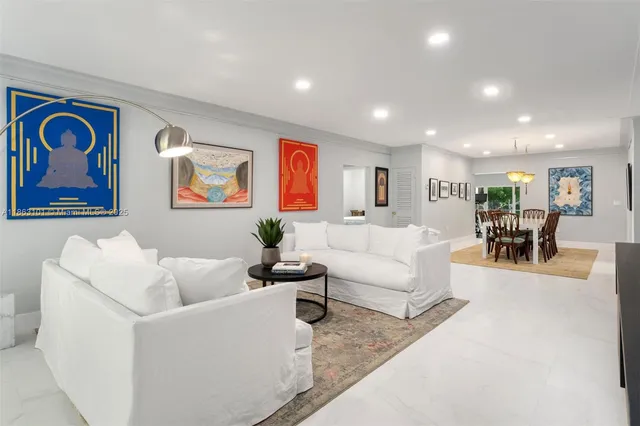 a living room with furniture and painting on the wall