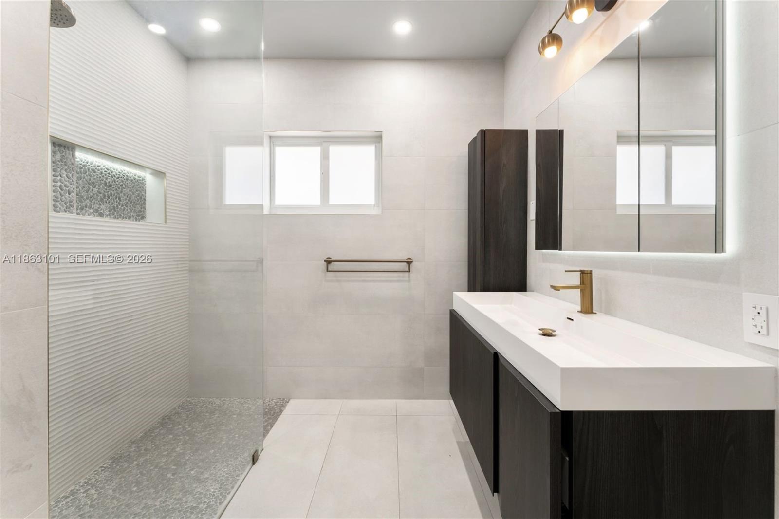 1410 Cleveland Road Miami Beach, FL 33141 - Photo 10 of 17 a bathroom with a double vanity sink and a mirror