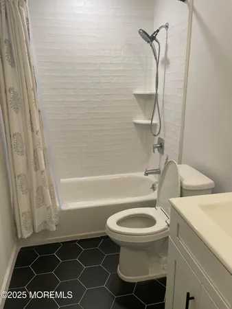 a bathroom with a sink a toilet and a shower