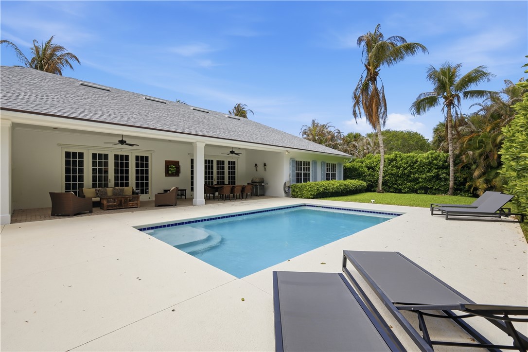 a view of a house with swimming pool and a yard