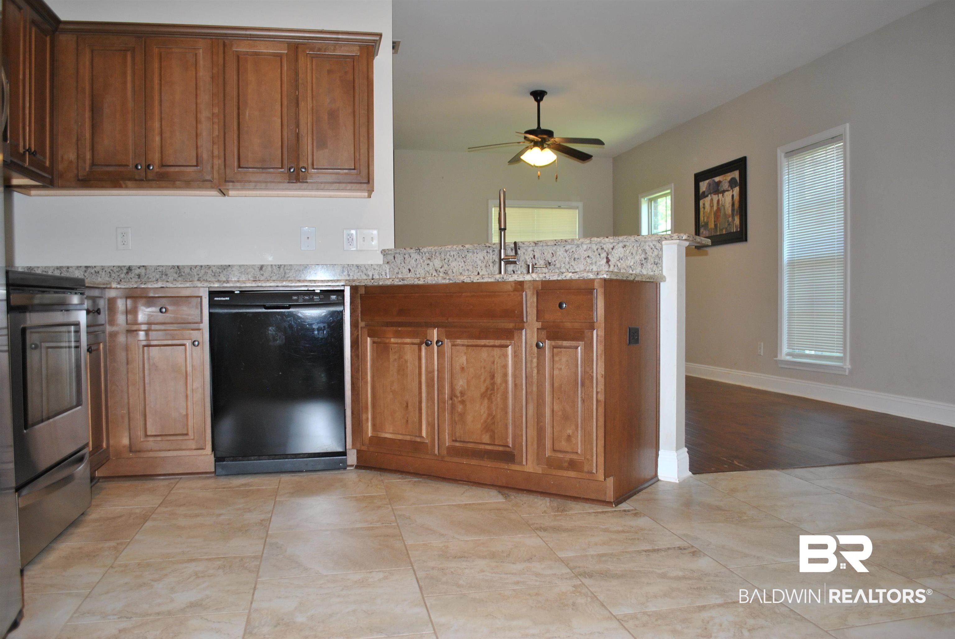 2161 Spring Grove West Mobile, AL 36695 - Photo 13 of 31 Kitchen with dishwasher, a peninsula, ceiling fan, electric range, and light stone counters