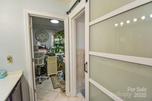 a view of a hallway and a livingroom with furniture