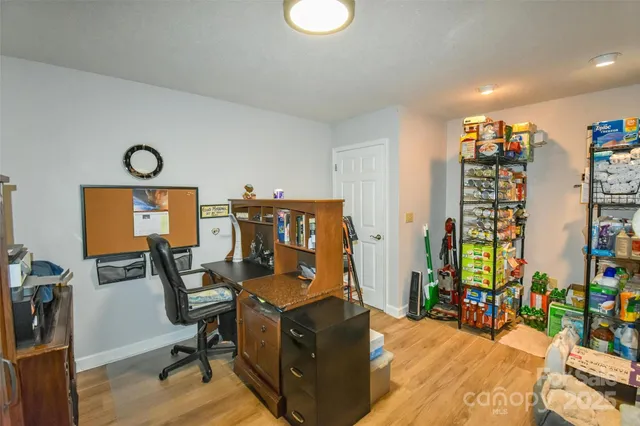 a view of a workspace with furniture and closet