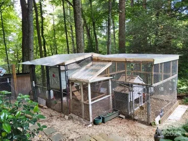 a view of a patio with a table and chairs under an umbrella