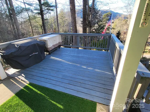 a view of balcony with wooden floor and fence