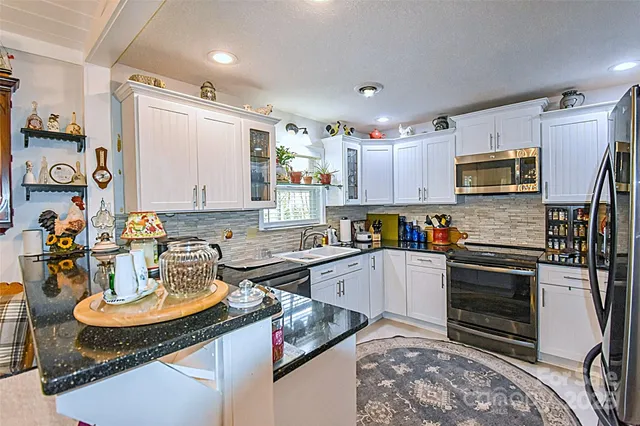a kitchen with a stove a sink and a refrigerator