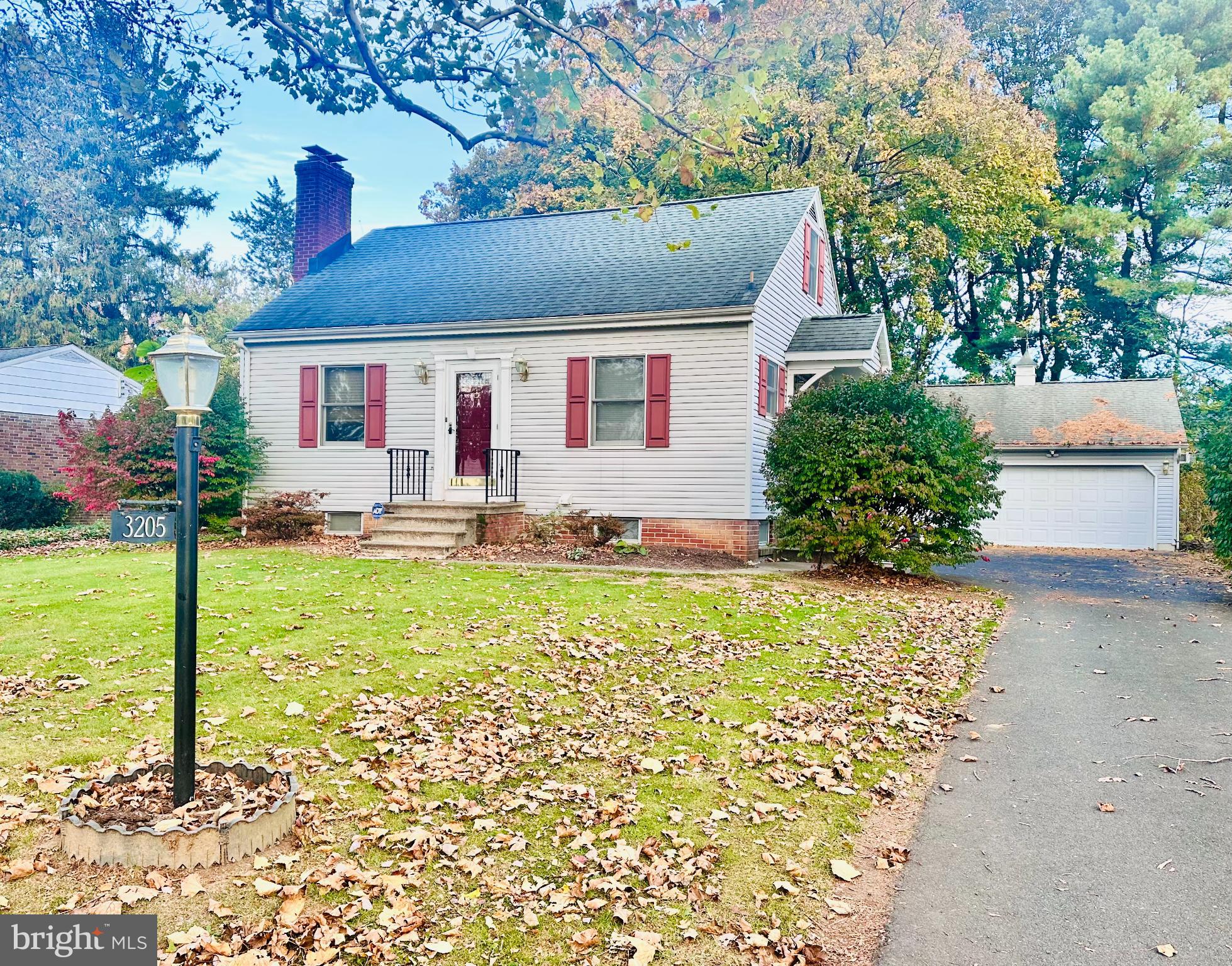 Charming home with lush autumn landscape.
