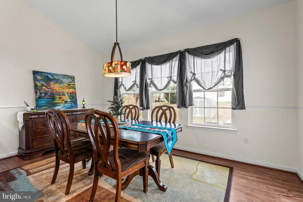a dining room with furniture a livingroom and wooden floor