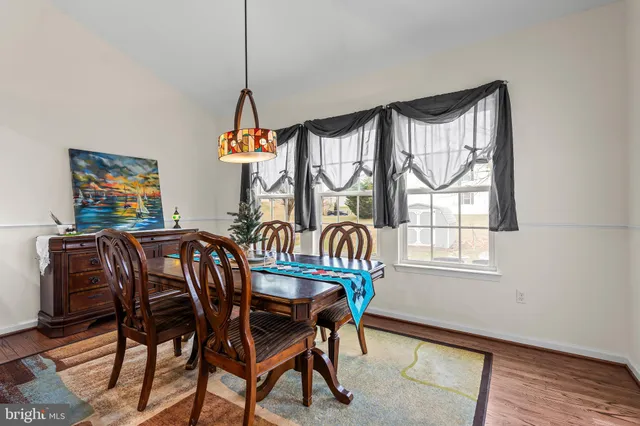 a dining room with furniture a livingroom and wooden floor