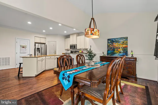 a view of a dining room with furniture wooden floor and a chandelier