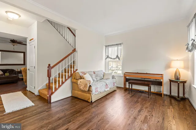 a bedroom with furniture and a wooden floor