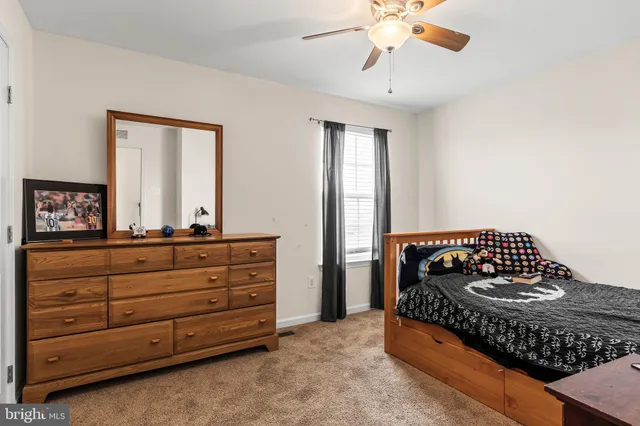 a bathroom with a sink a toilet and shower curtain
