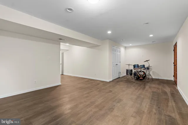 a view of a room with wooden floor