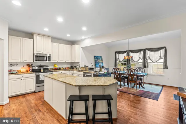 a large kitchen with a table and chairs
