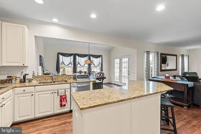 a kitchen with sink stove and cabinets