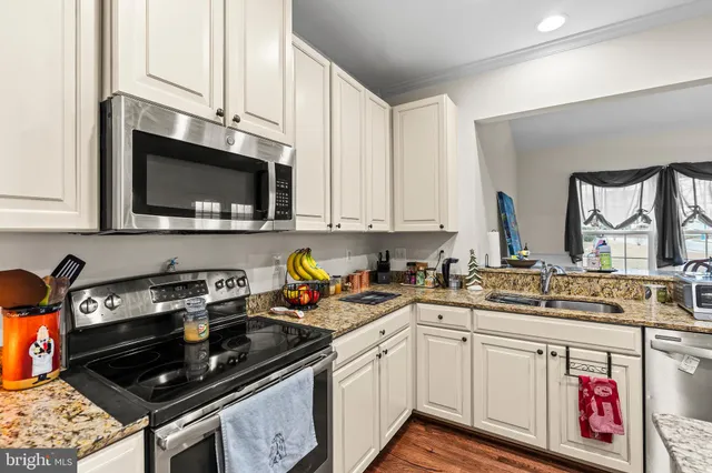a kitchen with stainless steel appliances a sink stove and microwave