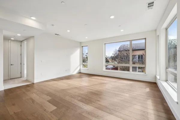 a large kitchen with stainless steel appliances and a large window