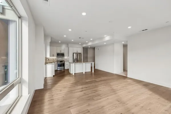a kitchen with stainless steel appliances a refrigerator and a stove top oven