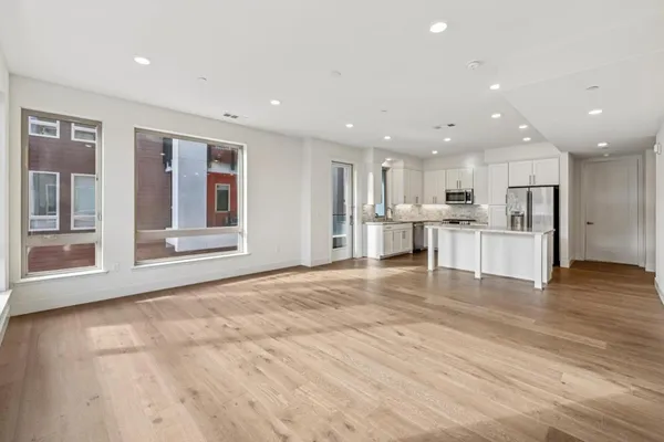 a kitchen with stainless steel appliances granite countertop a stove microwave and sink
