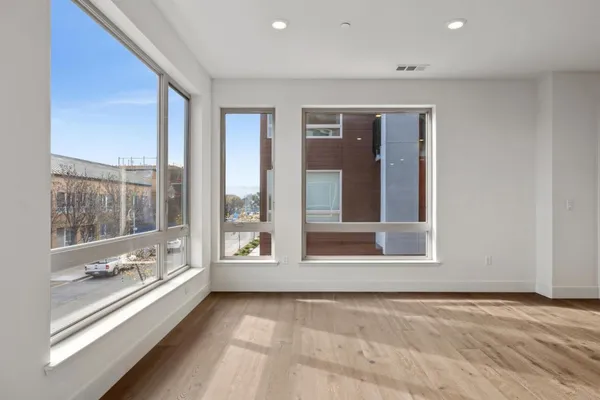 a kitchen with granite countertop a sink stove and refrigerator