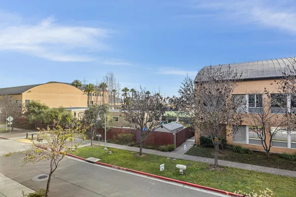 a kitchen with granite countertop white cabinets white stainless steel appliances and a sink