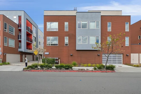 a view of an empty room with furniture and wooden floor
