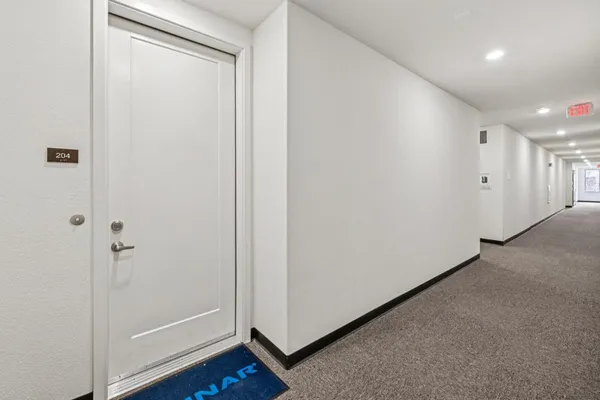 a view of kitchen with kitchen island and stainless steel appliances