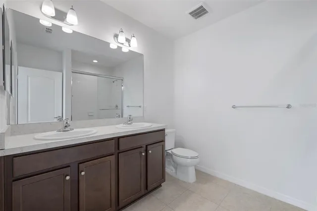 an empty room with a ceiling fan and a fan