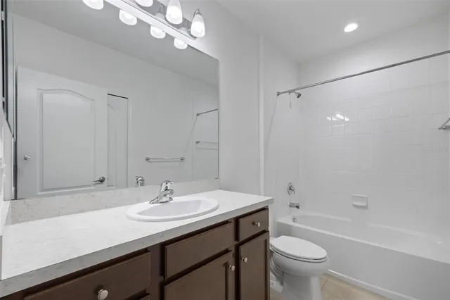 an empty room with a ceiling fan and a window