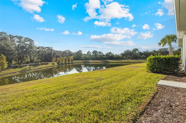 an aerial view of residential houses with outdoor space and ocean view