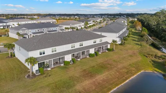 an aerial view of a residential houses with outdoor space