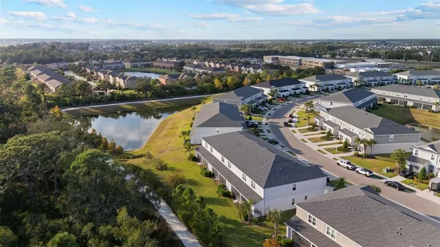 an aerial view of a house with swimming pool and ocean view